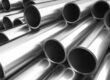 Several shiny metal tubes are stacked together, with their open circular ends facing toward the viewer.