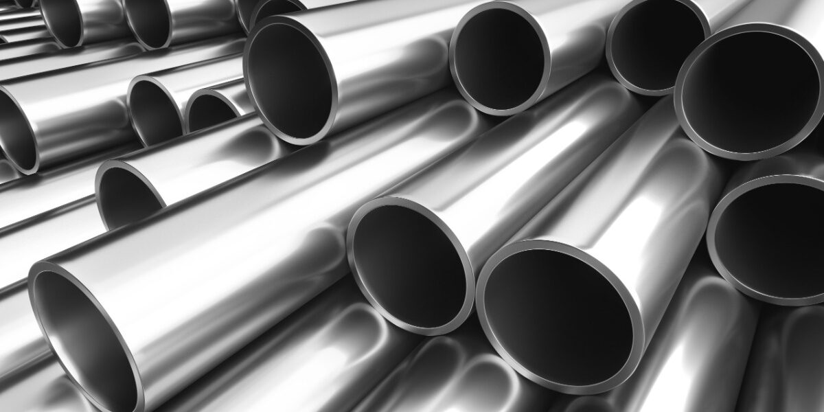 Several shiny metal tubes are stacked together, with their open circular ends facing toward the viewer.